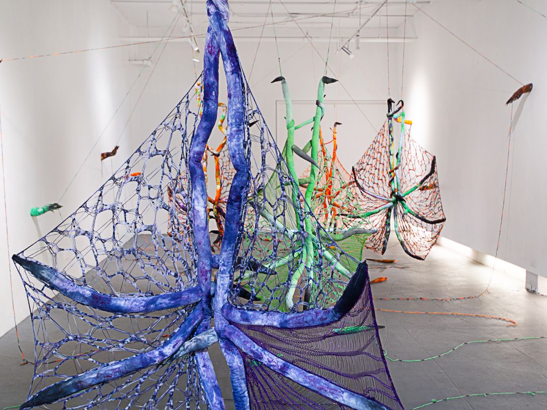 Hand dyed soft sculpture shaped in large bat-like wings where the membranes are knitted with beads.