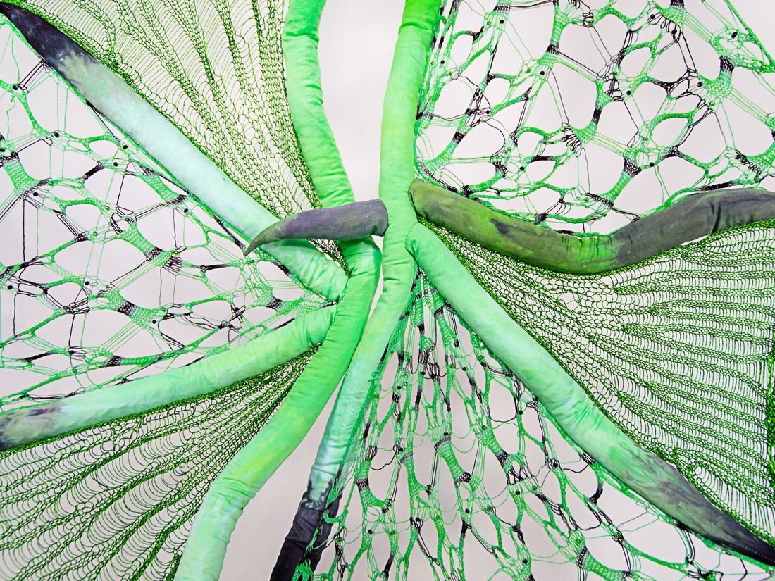 Hand dyed soft sculpture shaped in large bat-like wings where the membranes are knitted with beads.