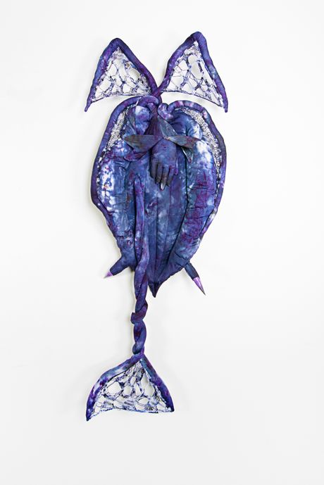 Hand dyed soft sculpture shaped like a budding plant with wings where the membranes are knitted with beads.