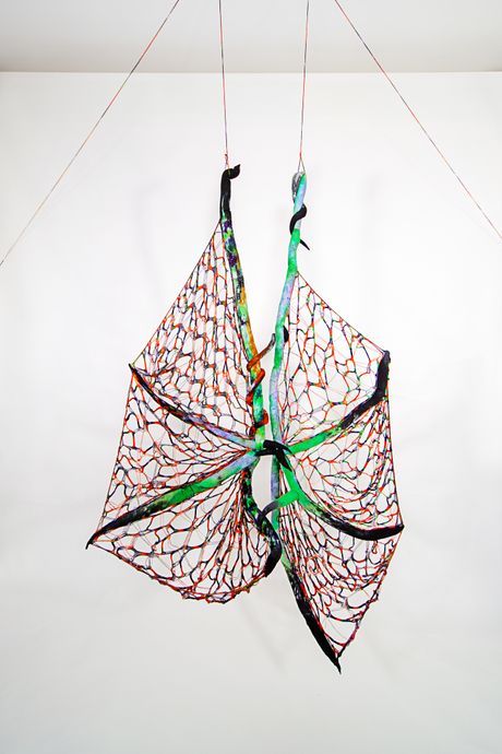 Hand dyed soft sculpture shaped in large bat-like wings where the membranes are knitted with beads.