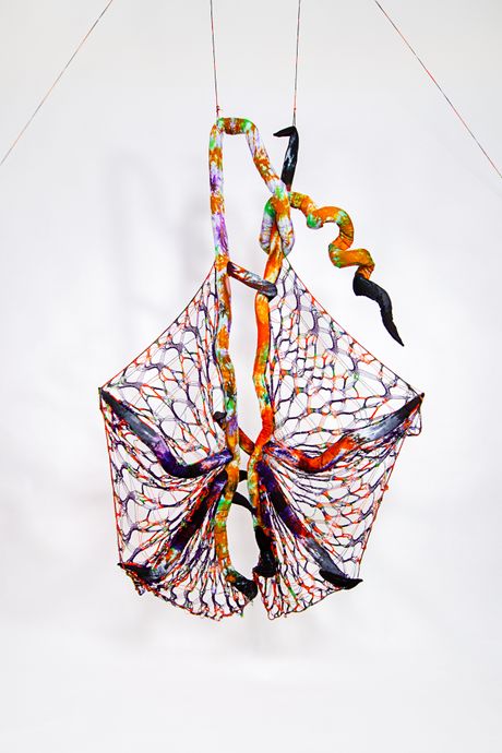 Hand dyed soft sculpture shaped in large bat-like wings where the membranes are knitted with beads.