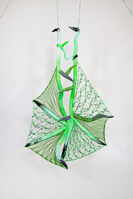 Hand dyed soft sculpture shaped in large bat-like wings where the membranes are knitted with beads.