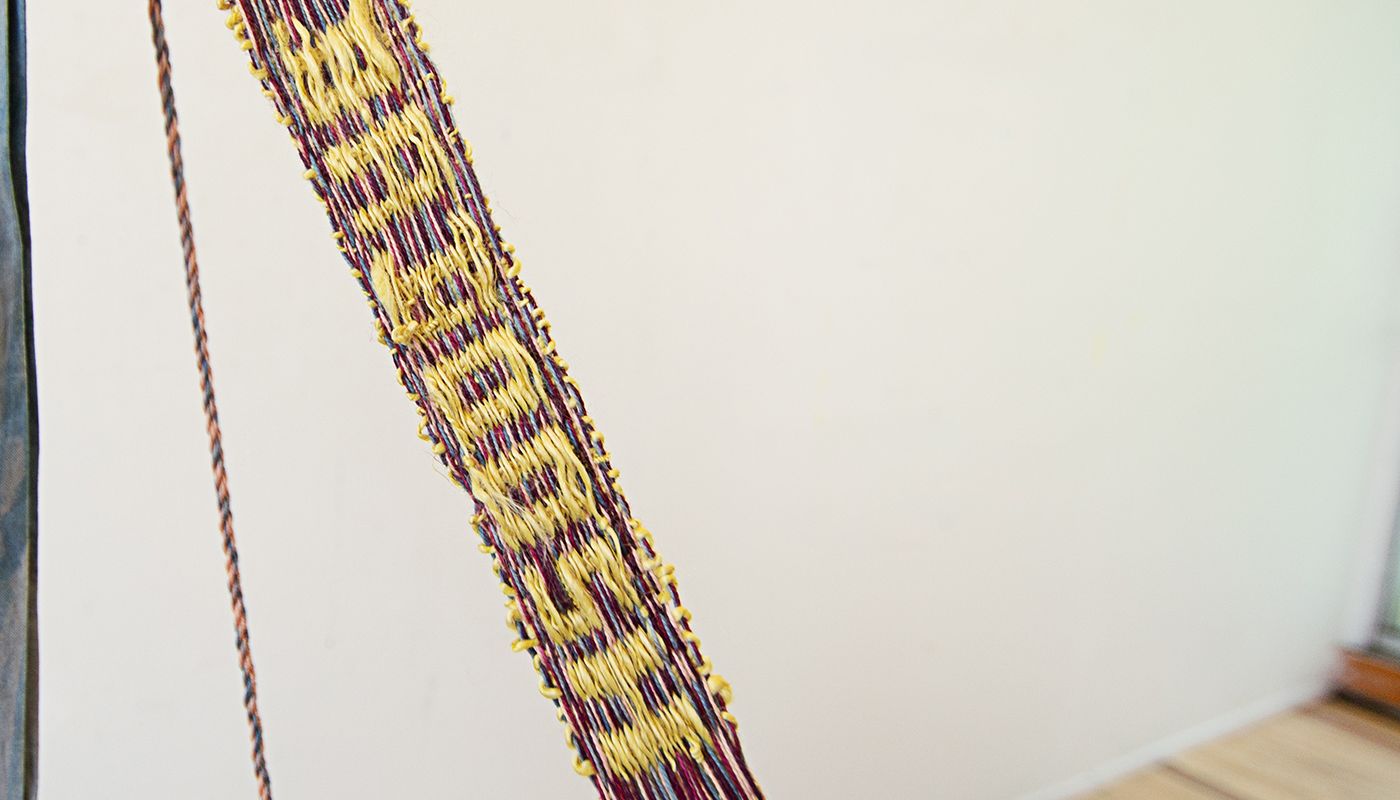 Colorful woven forms using backstrap weaving on fabric posts dyed with onion skins, indigo, avocado skins and pits, goldenrod, and sappanwood.